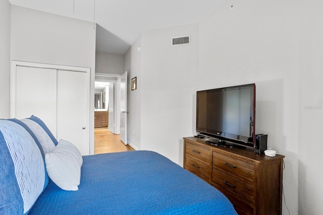 bedroom with light hardwood / wood-style flooring and a closet