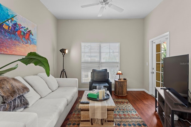 living room featuring dark hardwood / wood-style flooring and ceiling fan