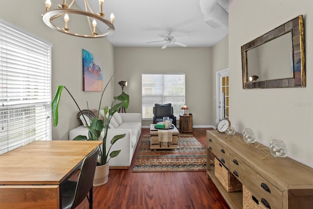 living room featuring dark hardwood / wood-style floors and ceiling fan with notable chandelier