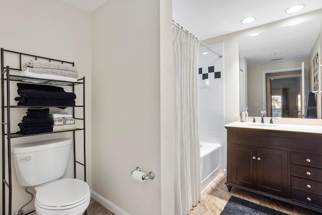 full bathroom featuring hardwood / wood-style flooring, shower / bath combo, toilet, and vanity