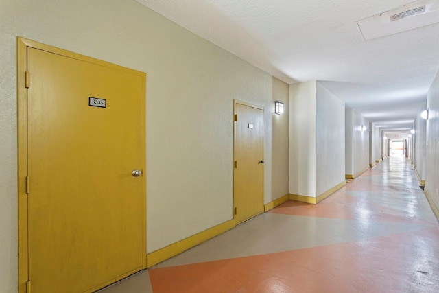 corridor with a textured ceiling