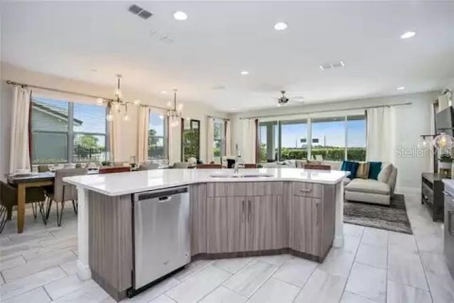 kitchen featuring dishwasher, a spacious island, sink, and ceiling fan with notable chandelier