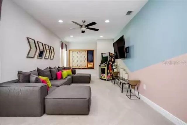 carpeted living room featuring ceiling fan