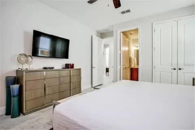 bedroom featuring connected bathroom, a closet, and ceiling fan