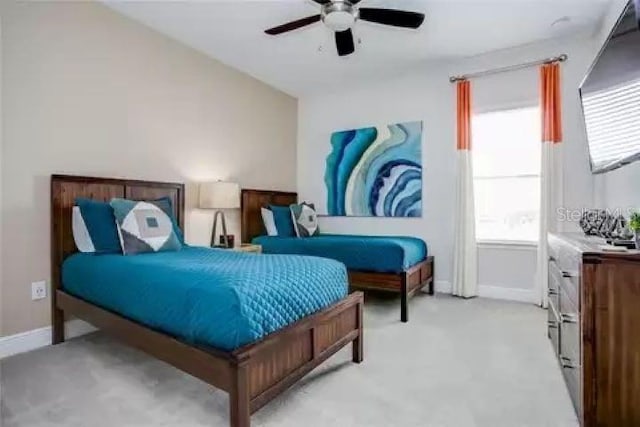 bedroom with ceiling fan and light carpet