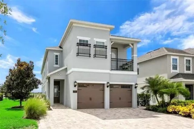 view of front of house featuring a balcony and a garage