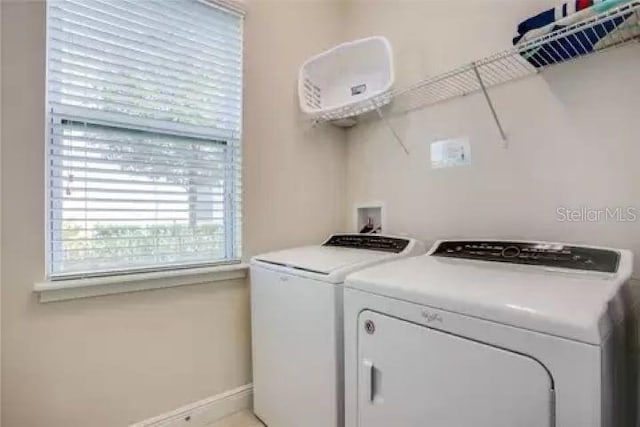 washroom with washing machine and clothes dryer