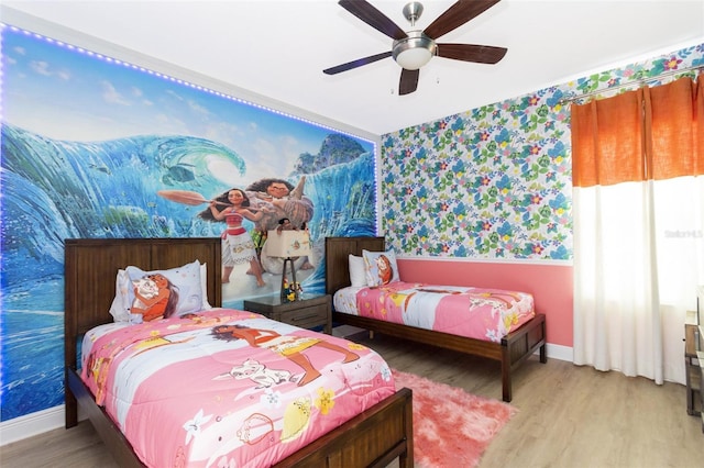 bedroom with ceiling fan and light hardwood / wood-style floors