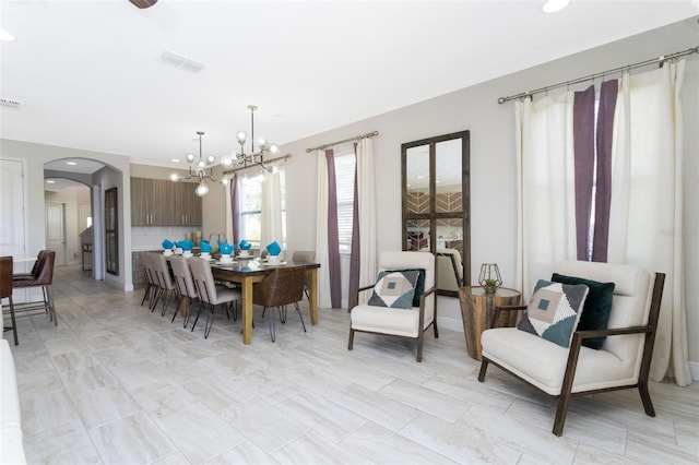 dining area featuring an inviting chandelier