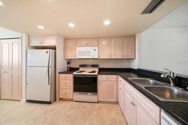 kitchen featuring light brown cabinetry, light carpet, sink, and white appliances