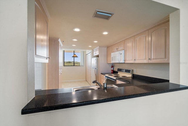 kitchen featuring kitchen peninsula, white appliances, and sink