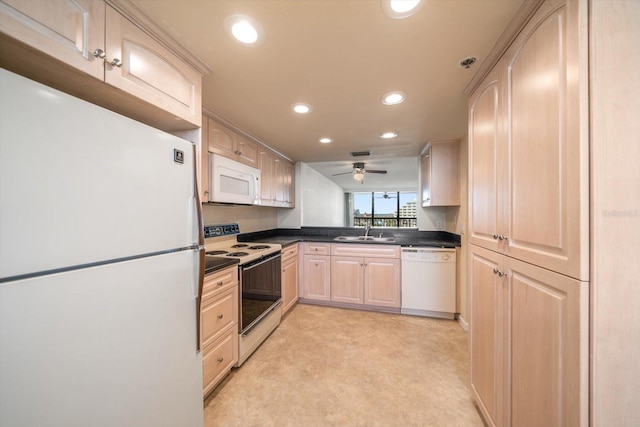 kitchen featuring light brown cabinets, white appliances, sink, and light carpet