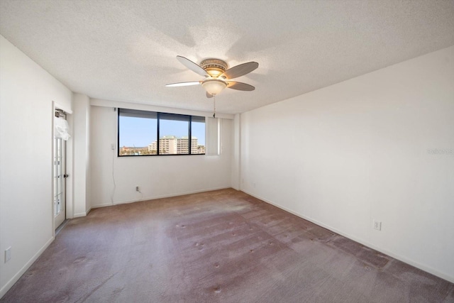 empty room featuring carpet and a textured ceiling