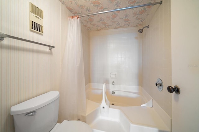 bathroom with shower / bath combo with shower curtain and toilet