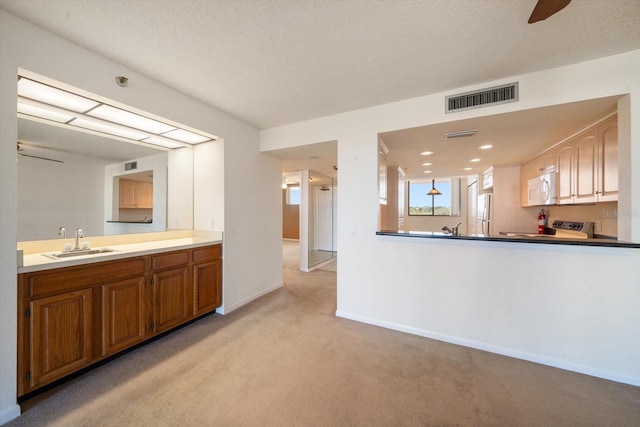 bathroom with a textured ceiling and sink