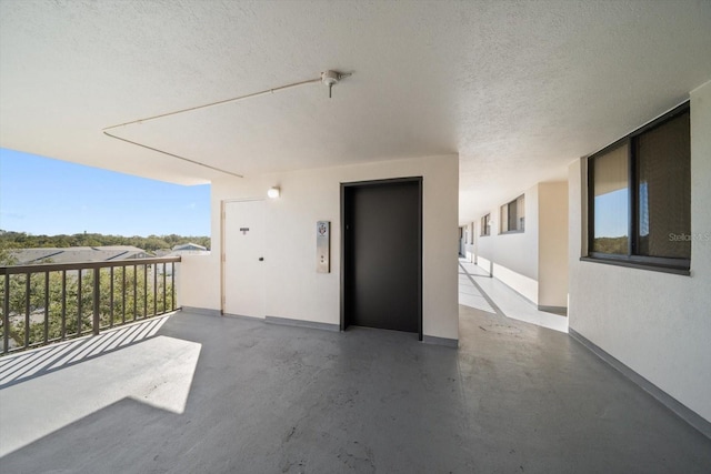 view of patio / terrace featuring elevator and a balcony