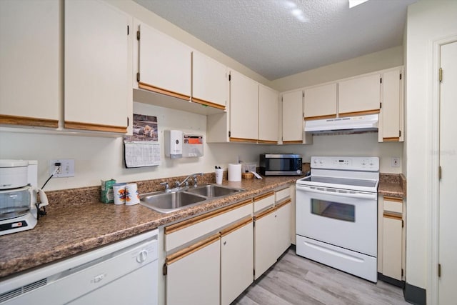 kitchen featuring light hardwood / wood-style floors, white cabinetry, white appliances, and a textured ceiling