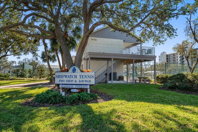 surrounding community with a wooden deck and a lawn