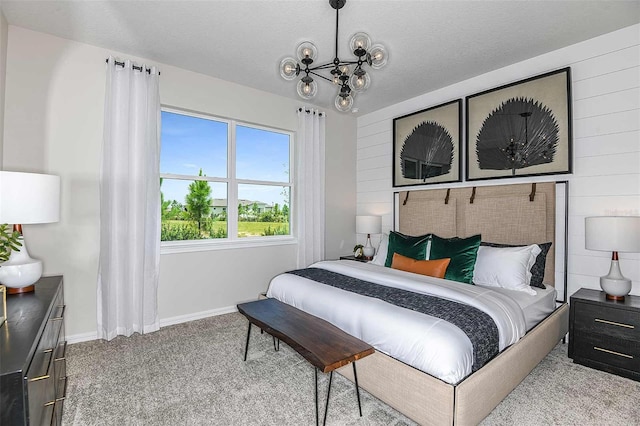 carpeted bedroom featuring a chandelier