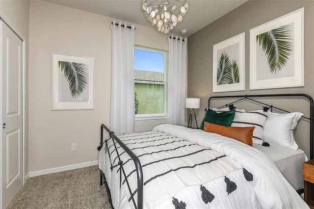 carpeted bedroom featuring a closet and a notable chandelier