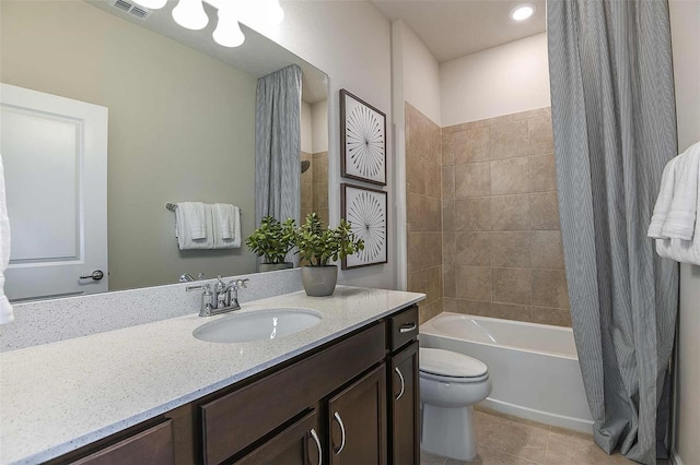 full bathroom with shower / bath combo with shower curtain, toilet, vanity, and tile patterned flooring