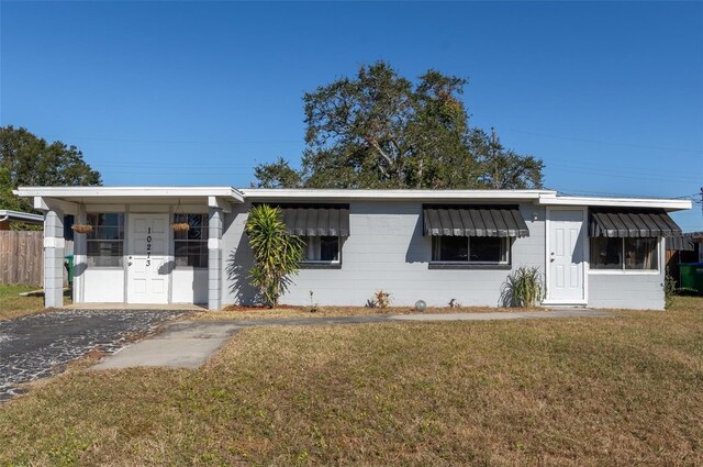 10273 109th Ave, Largo, FL 33773 - view of front facade featuring a front yard and concrete block siding