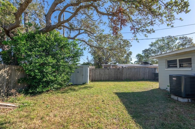 view of yard featuring a shed and central AC unit