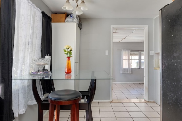10273 109th Ave, Largo, FL 33773 - dining area featuring light tile patterned flooring and a chandelier