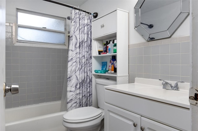 full bathroom with tile walls, vanity, shower / tub combo, and toilet