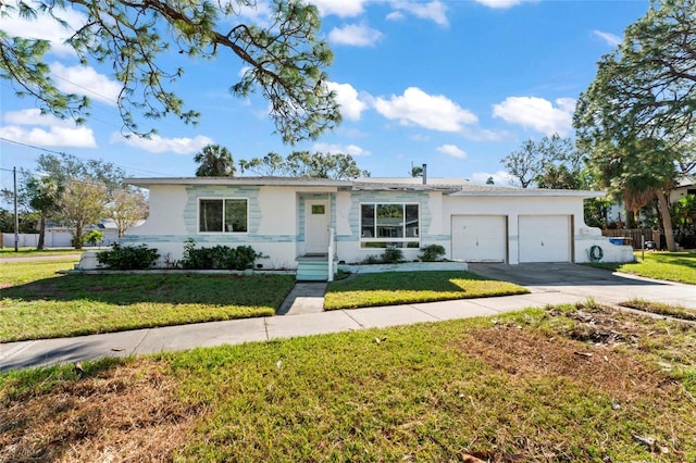 ranch-style house featuring a front yard and a garage