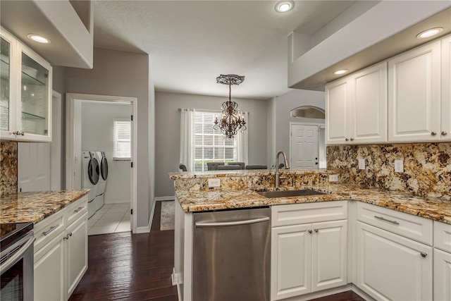 kitchen featuring washing machine and clothes dryer, white cabinets, and appliances with stainless steel finishes