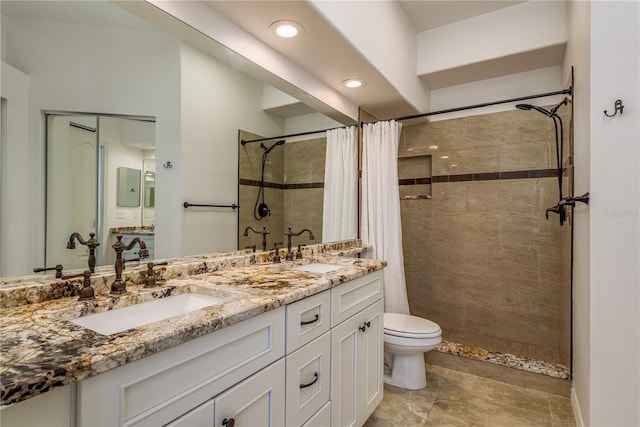 bathroom featuring vanity, curtained shower, and toilet