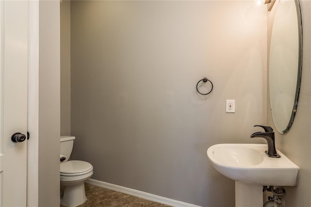 bathroom featuring tile patterned floors, toilet, and sink