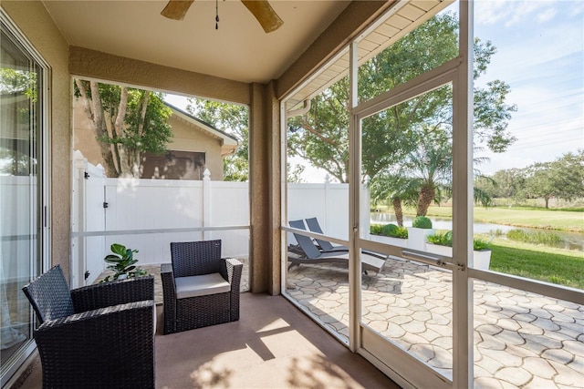 sunroom with ceiling fan and plenty of natural light