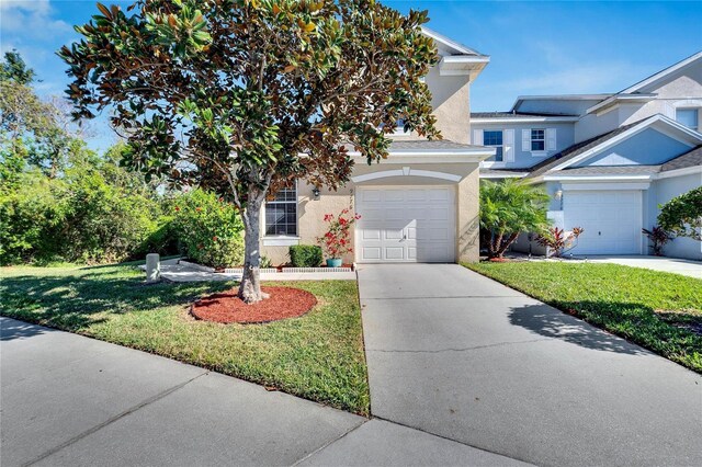 view of front of property featuring a garage and a front lawn