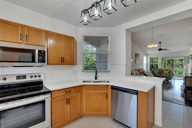 kitchen with sink, a healthy amount of sunlight, decorative light fixtures, and appliances with stainless steel finishes