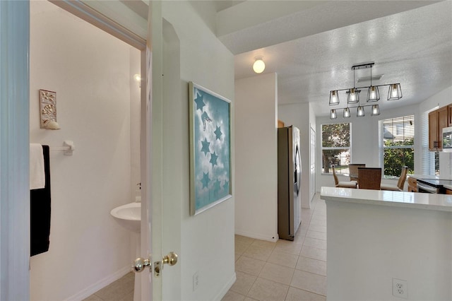 interior space featuring a textured ceiling and tile patterned floors