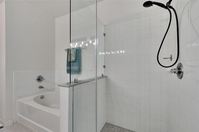 bathroom featuring tile patterned floors and shower with separate bathtub