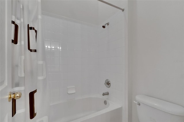 bathroom with shower / bath combo with shower curtain and toilet