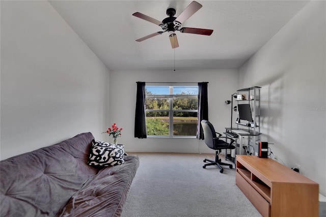 carpeted office space featuring ceiling fan