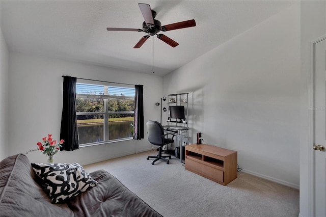 office space with ceiling fan and light carpet