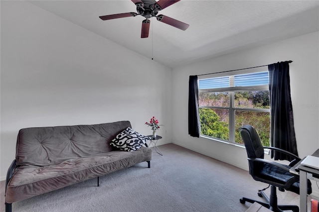 carpeted office space featuring a textured ceiling, ceiling fan, and lofted ceiling