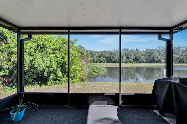 unfurnished sunroom with plenty of natural light and a water view