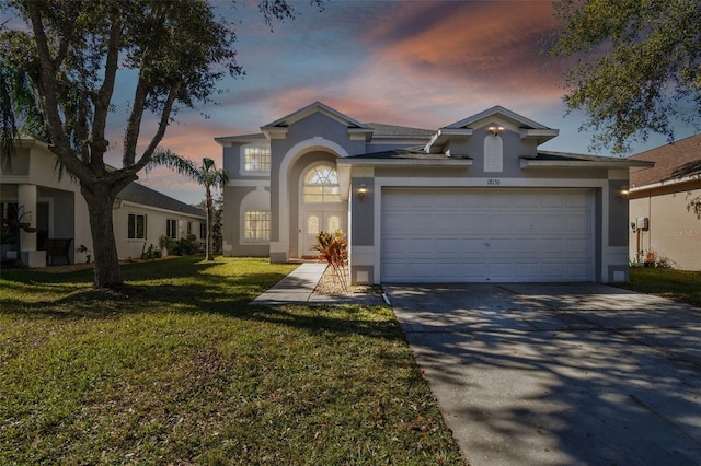 view of front of property featuring a lawn and a garage