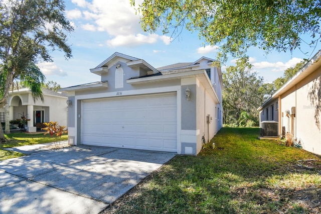 view of front of home featuring a front yard, a garage, and central AC unit