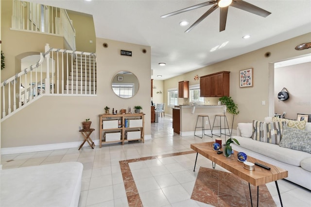 tiled living room with ceiling fan