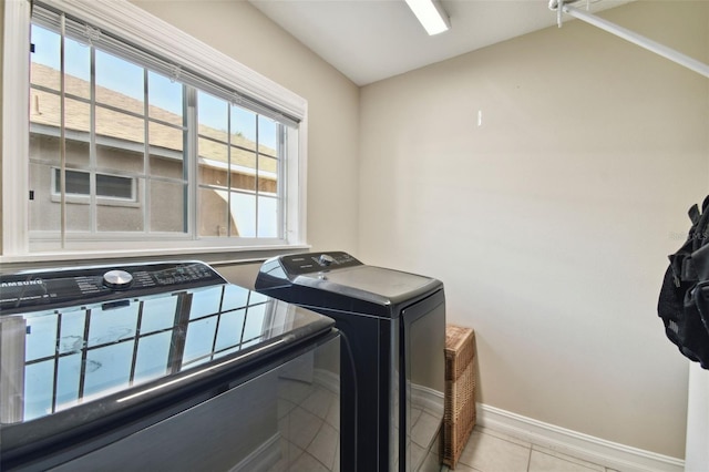 laundry area featuring separate washer and dryer and light tile patterned floors