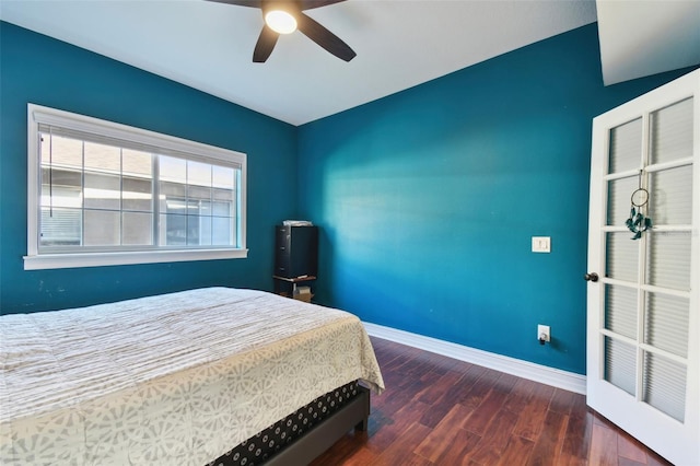 bedroom with dark hardwood / wood-style flooring and ceiling fan