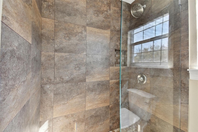 interior details featuring tiled shower