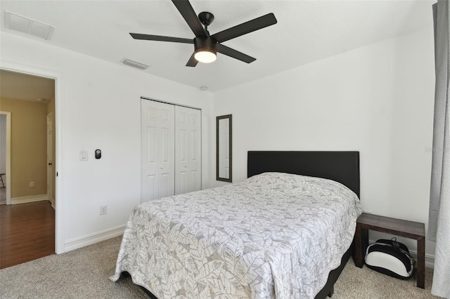 carpeted bedroom featuring a closet and ceiling fan